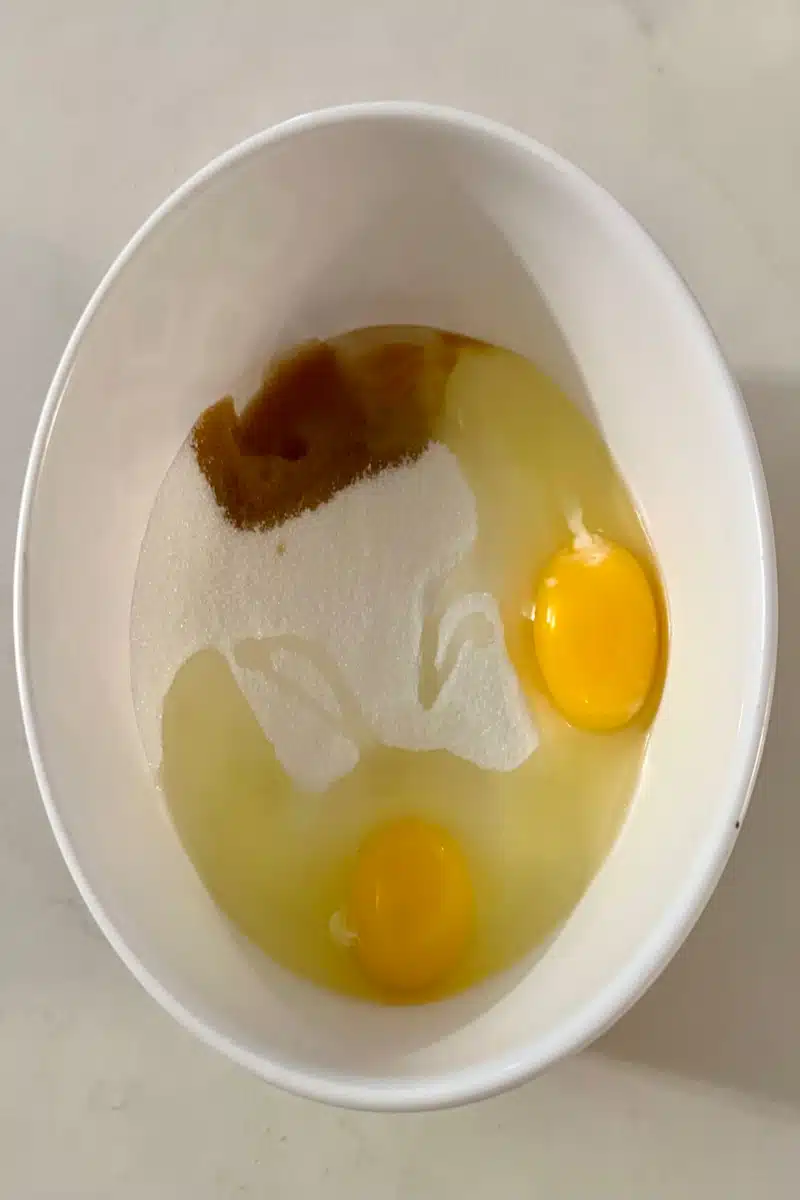 combining sugar, eggs and vanilla in a mixing bowl
