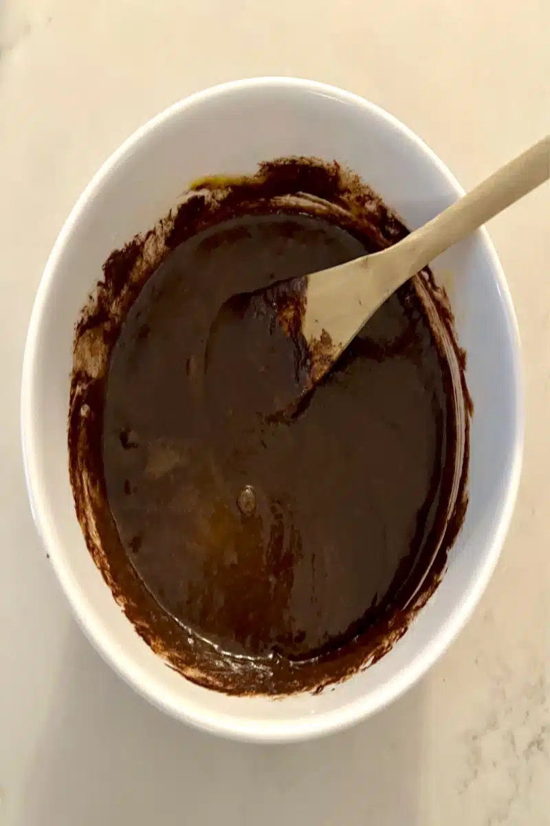 Adding chocolate to the sugar mixture