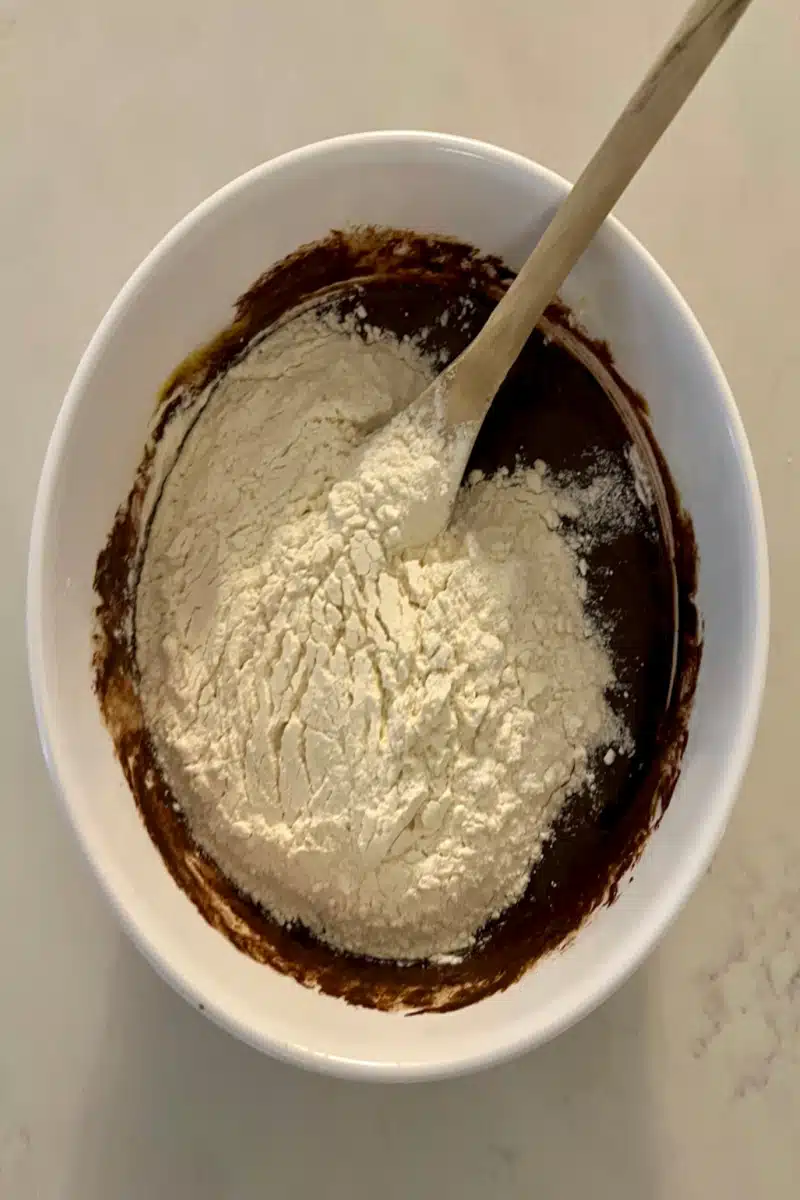 Adding flour to the chocolate batter