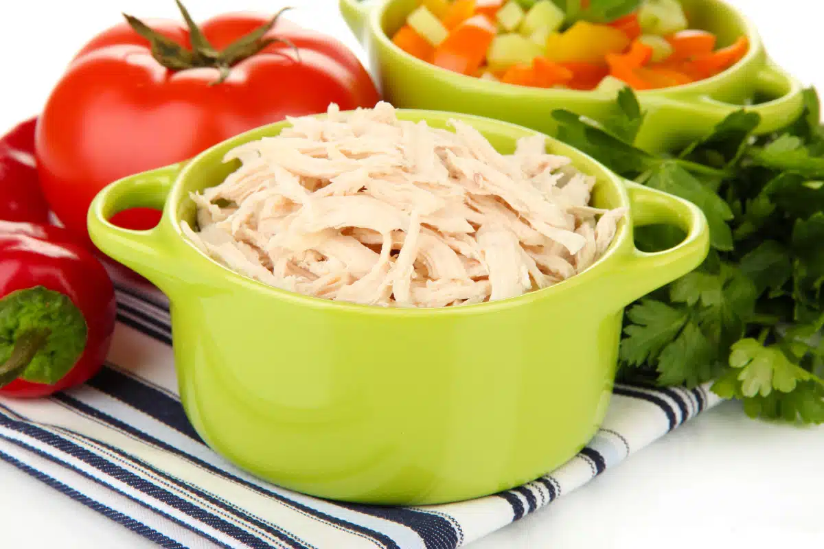 shredded chicken in a green pot