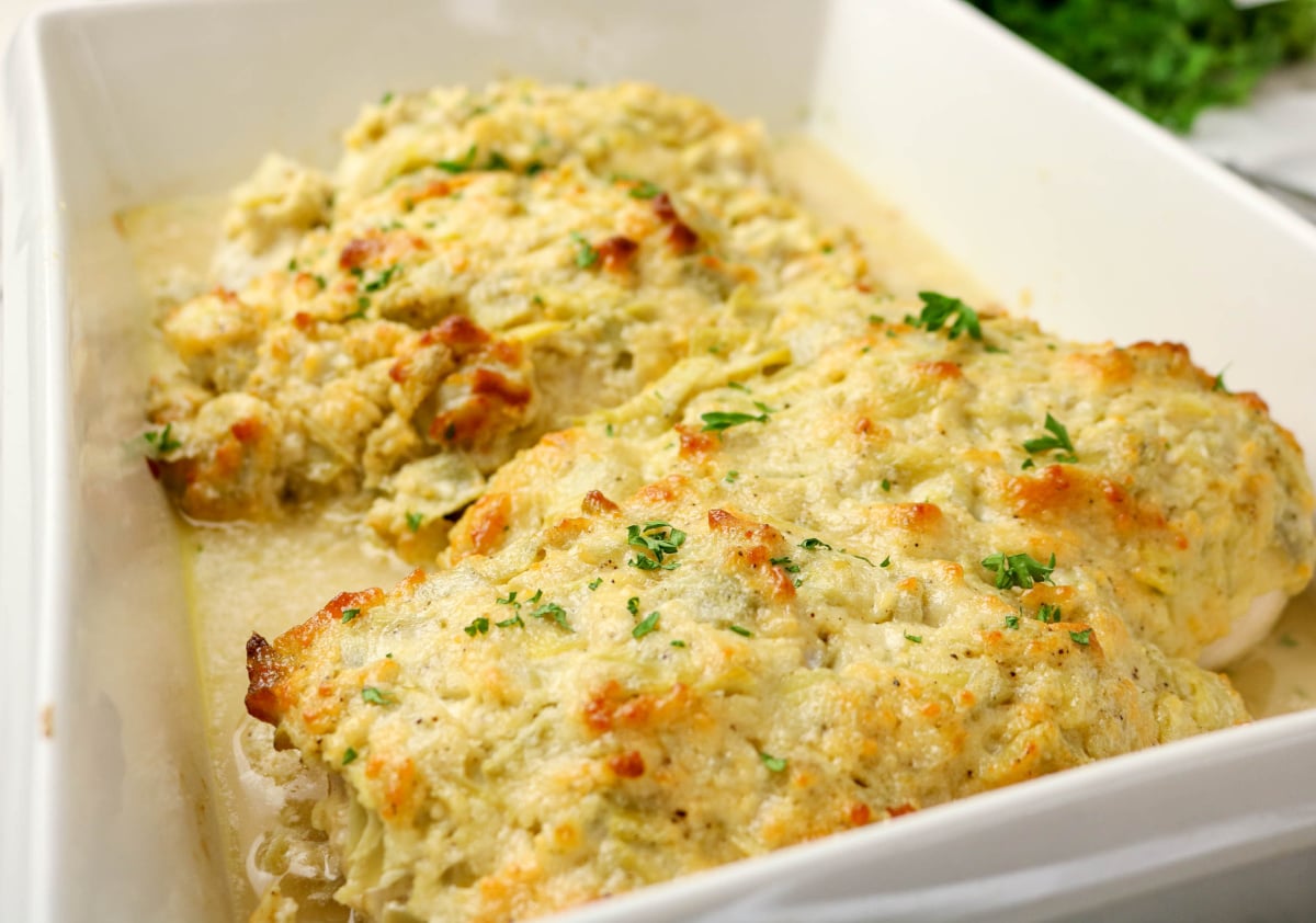 baked chicken and artichokes in a casserole dish