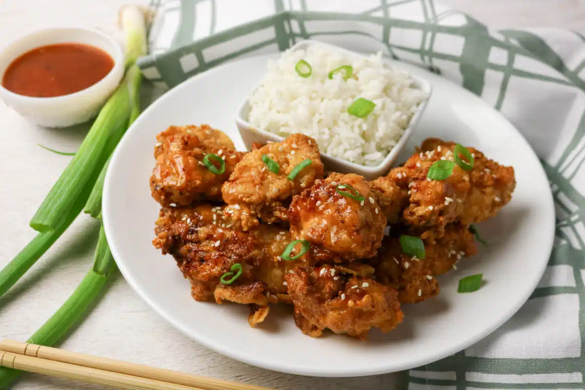 Bang Bang Chicken with rice on a round plate