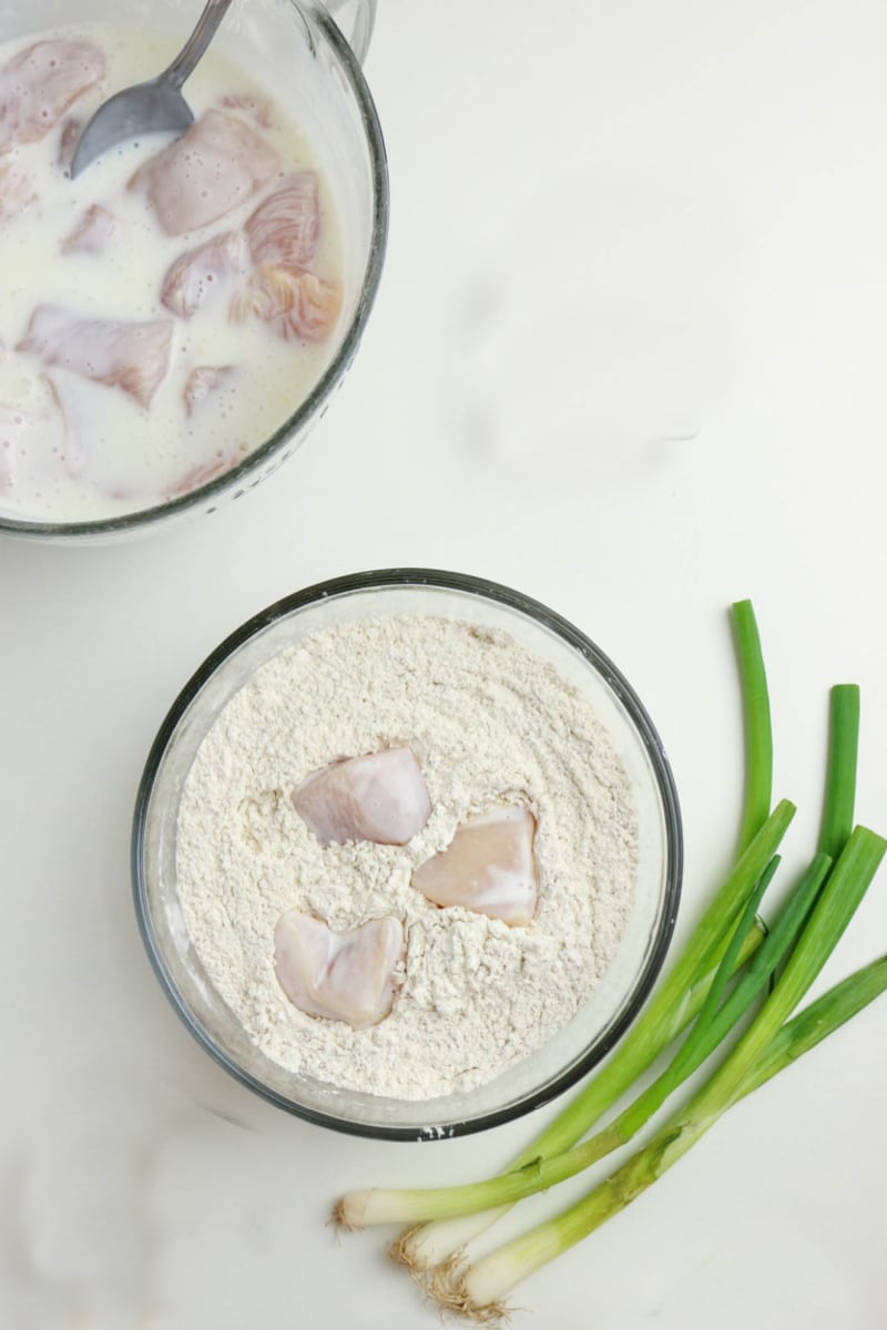 coating chicken pieces in flour mixture