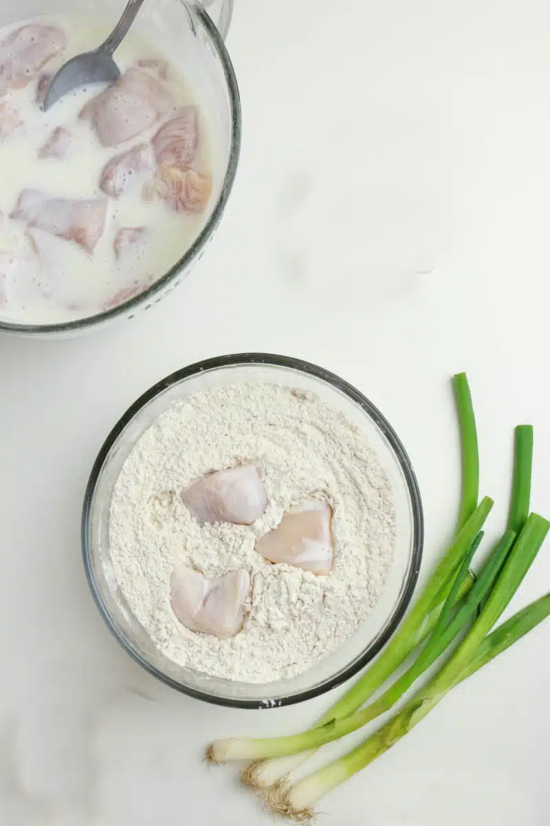 coating chicken pieces in flour mixture