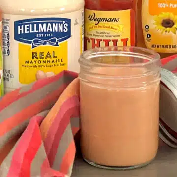 bang bang sauce in a jar with ingredients behind it