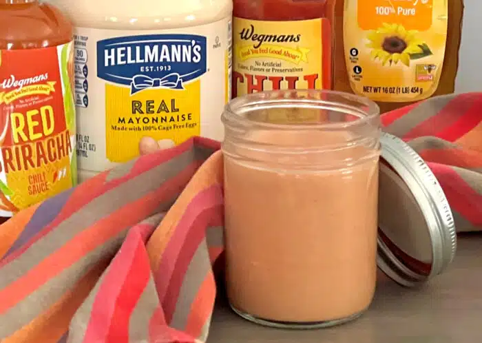 bang bang sauce in a jar with ingredients behind it