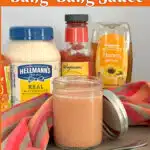 homemade bang bang sauce with ingredients and a pretty napkin and text overlay