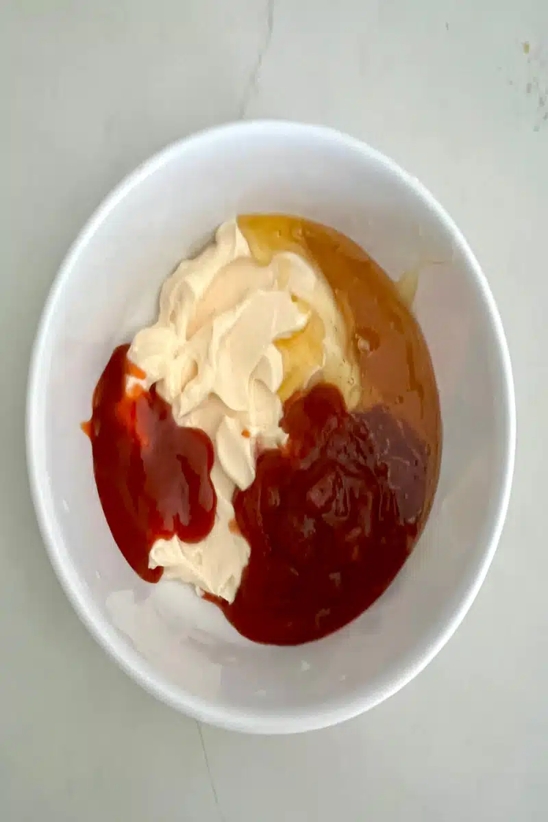 combining ingredients in a mixing bowl for bang bang sauce