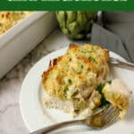 serving of creamy artichoke chicken on a plate with text overlay