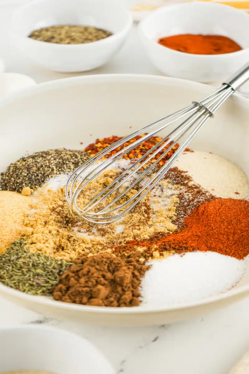 whisking spices together in a mixing bowl
