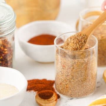 spoonful of jerk seasoning with other ingredients in bowls