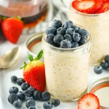 two mason jars with overnight oatmeal and fresh berries