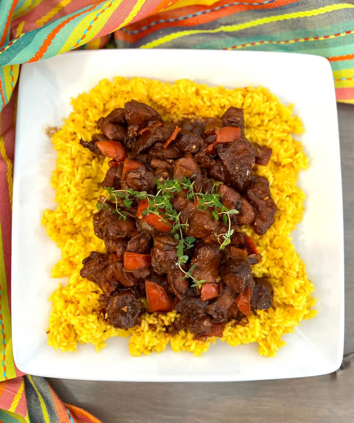 overhead of Browned Chicken Stew with yelloe rice and fresh thyme