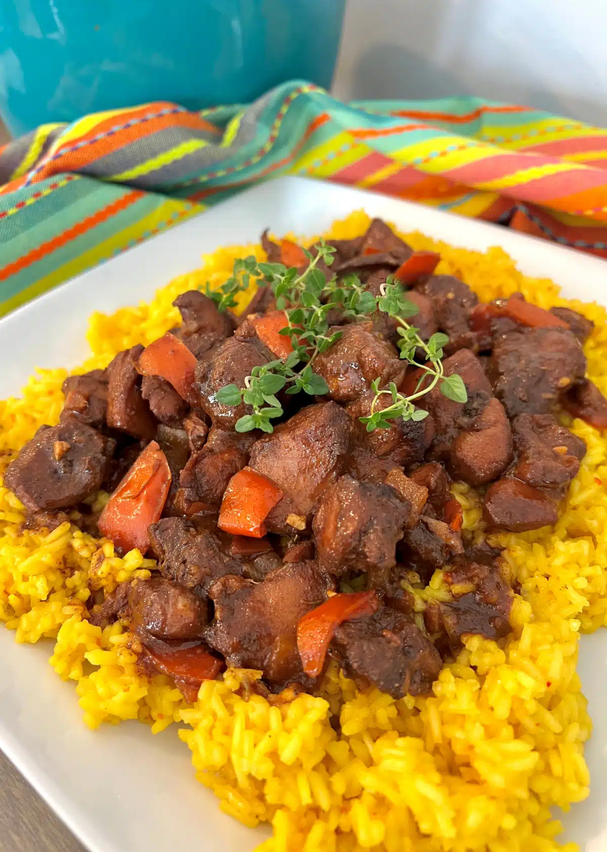 Browned Chicken Stew over a bed of yellow rice with fresh thyme