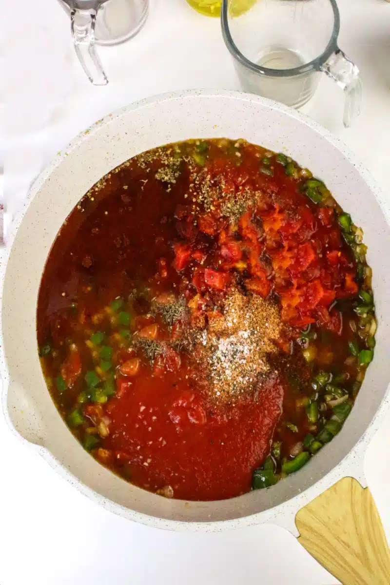 adding tomato sauce and diced tomatoes to the pot