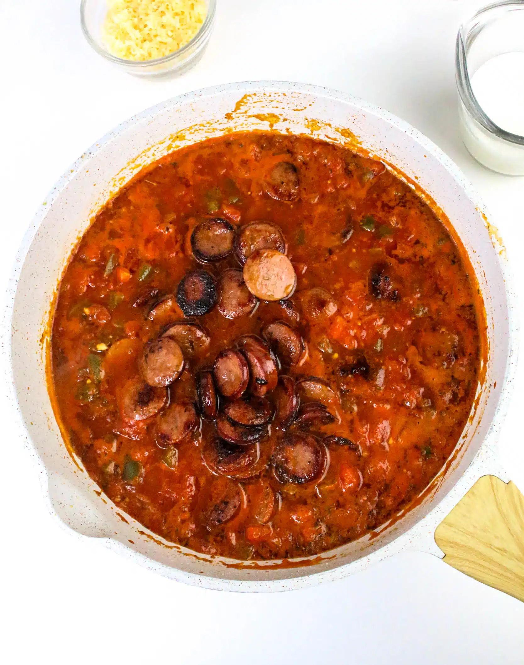 adding sausage to the skillet