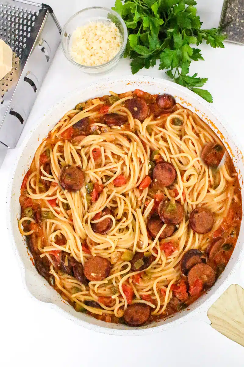 adding spaghetti to the skillet