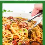serving Cajun sausage and spaghetti with tongs and text overlay
