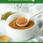 Cajun seasoning in bowl with spoon and text overlay