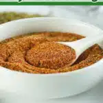 bowl of DIY Cajun seasoning with spoon and text overlay
