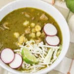 bowl of verde pork pozole with toppings