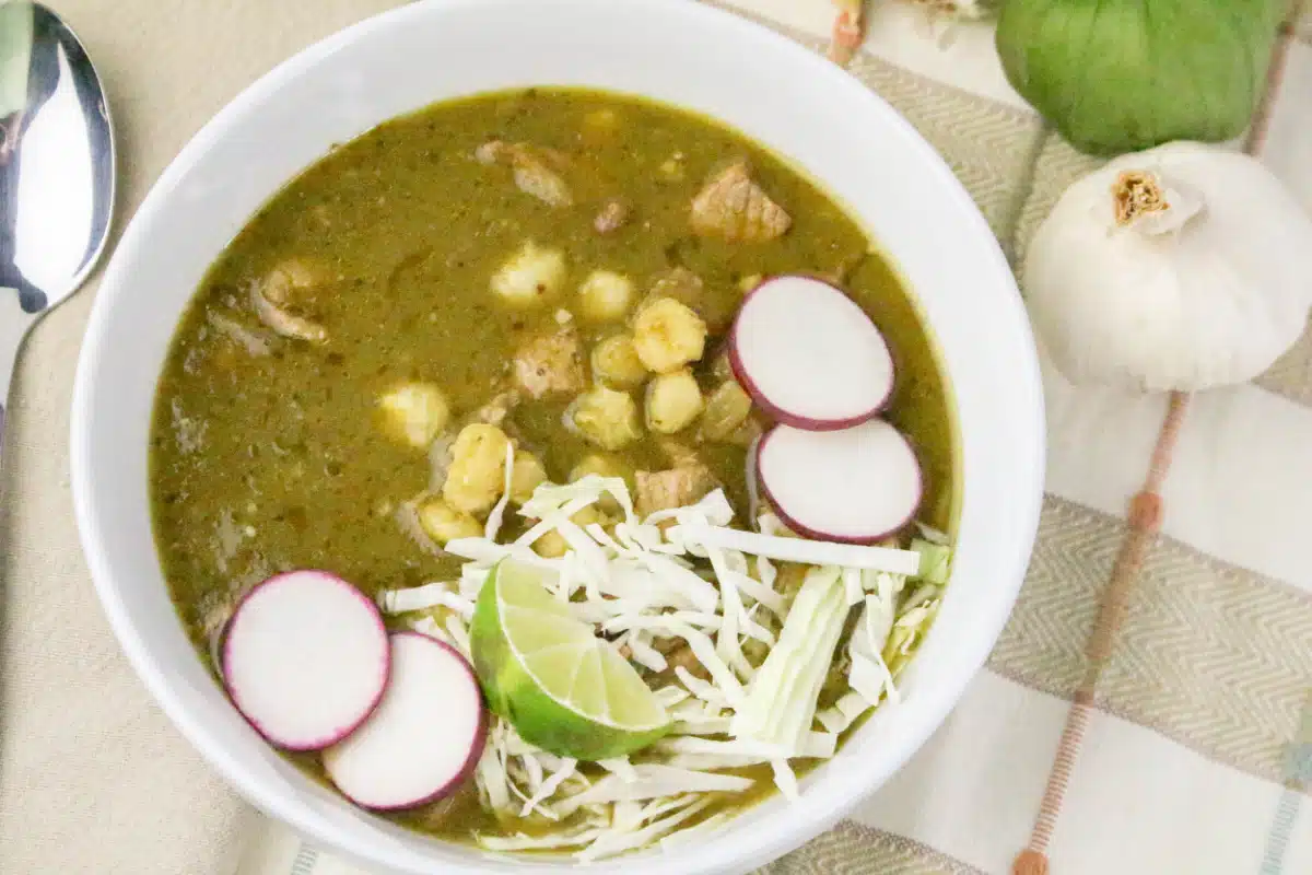 bowl of verde pork pozole with toppings