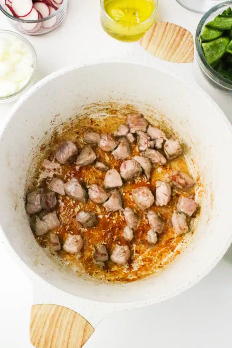 browning pork pieces in a pot