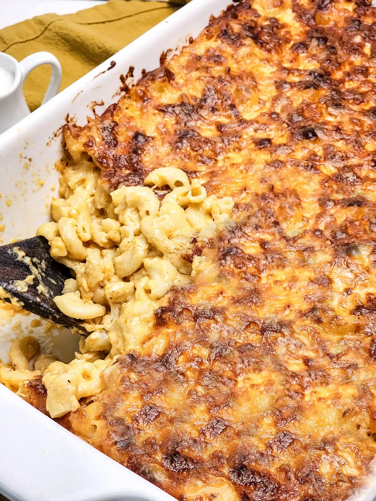 3 cheese mac and cheese in casserole dish with spoonful