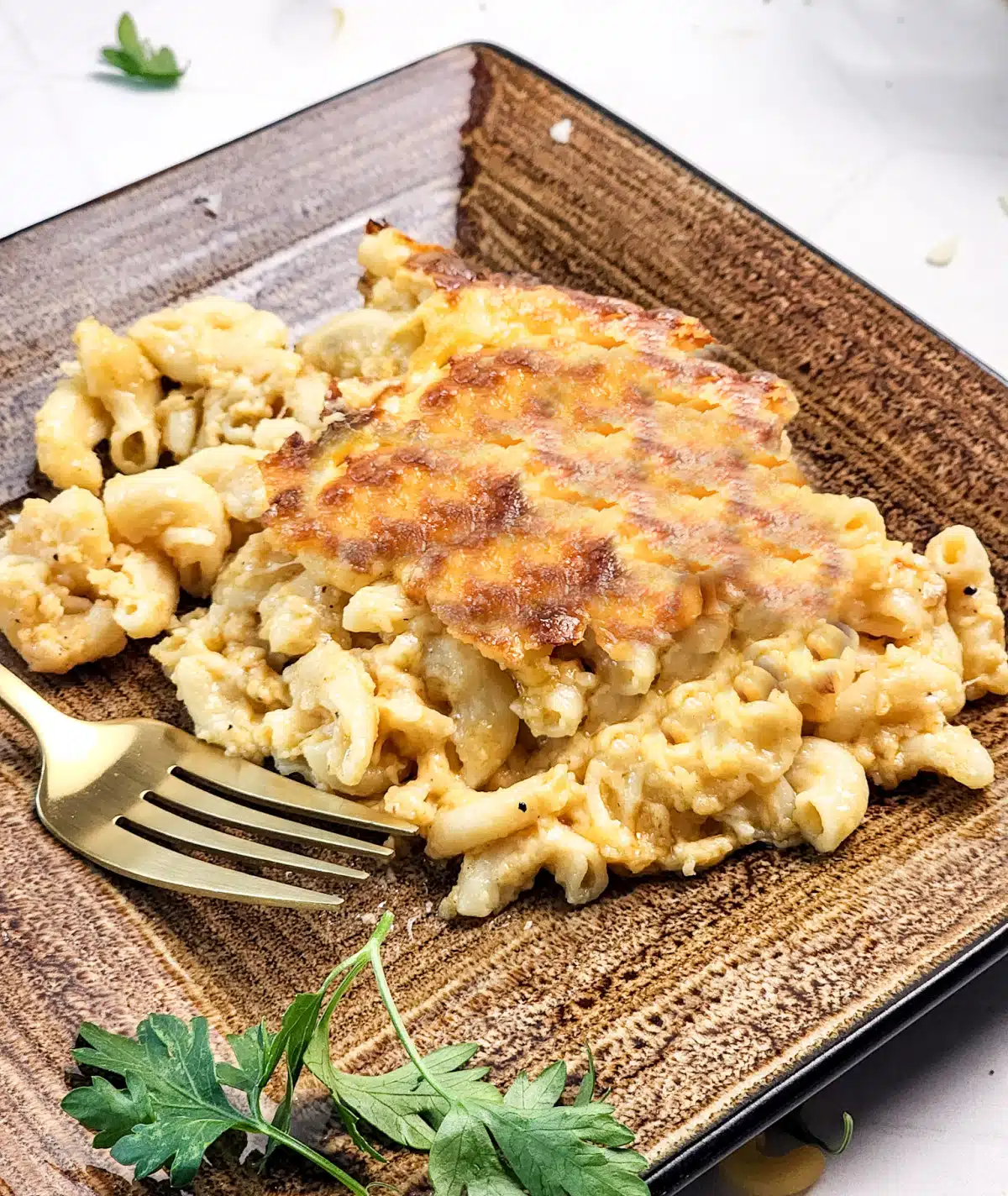 serving of macaroni and cheese on a plate with fork