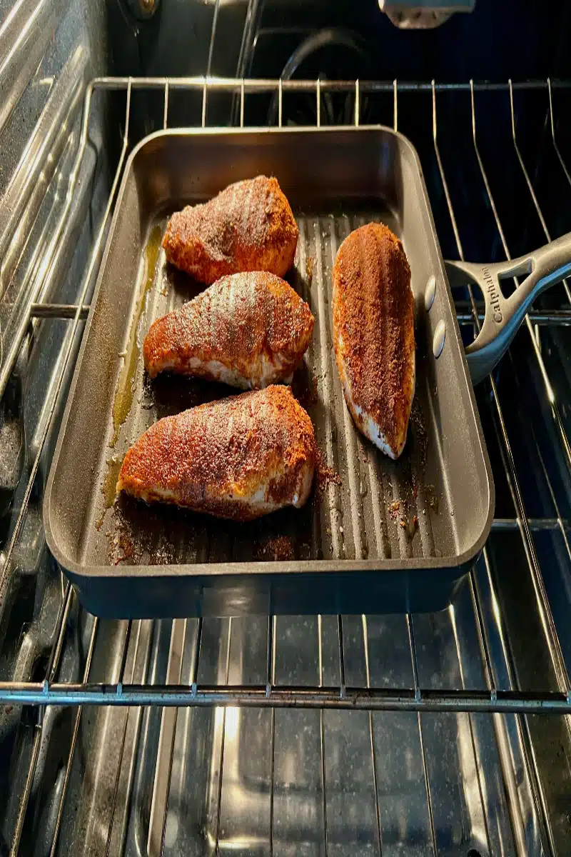 putting blackened chicken in the oven