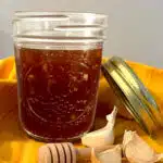 honey garlic sauce in a mason jar with a colorful napkin