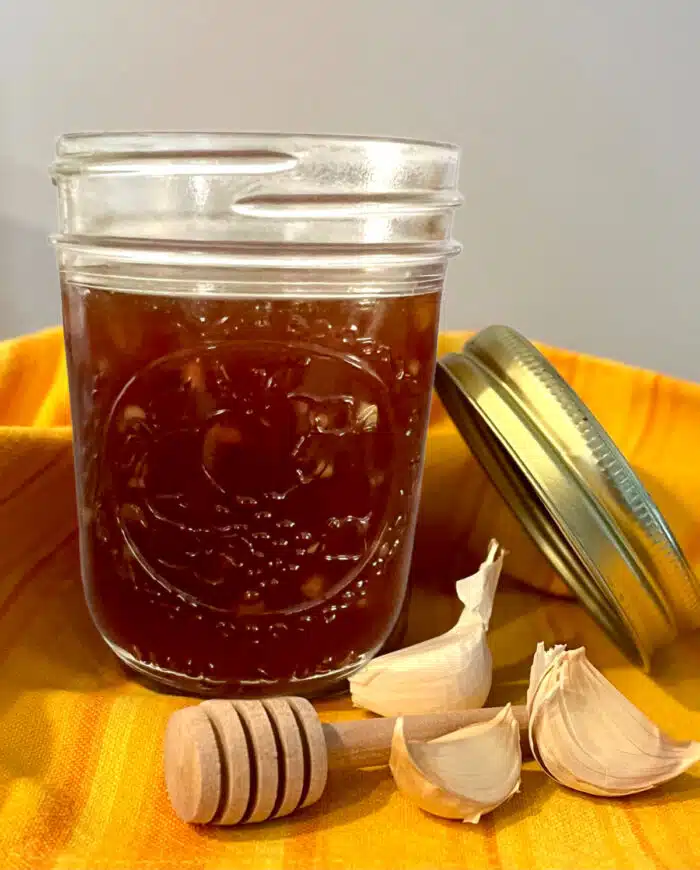 honey garlic sauce in a mason jar with a colorful napkin