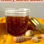 jar of honey garlic sauce with honey dipper and text overlay