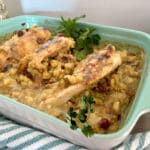 stuffed chicken breasts with stuffing and gravy in a blue baking dish
