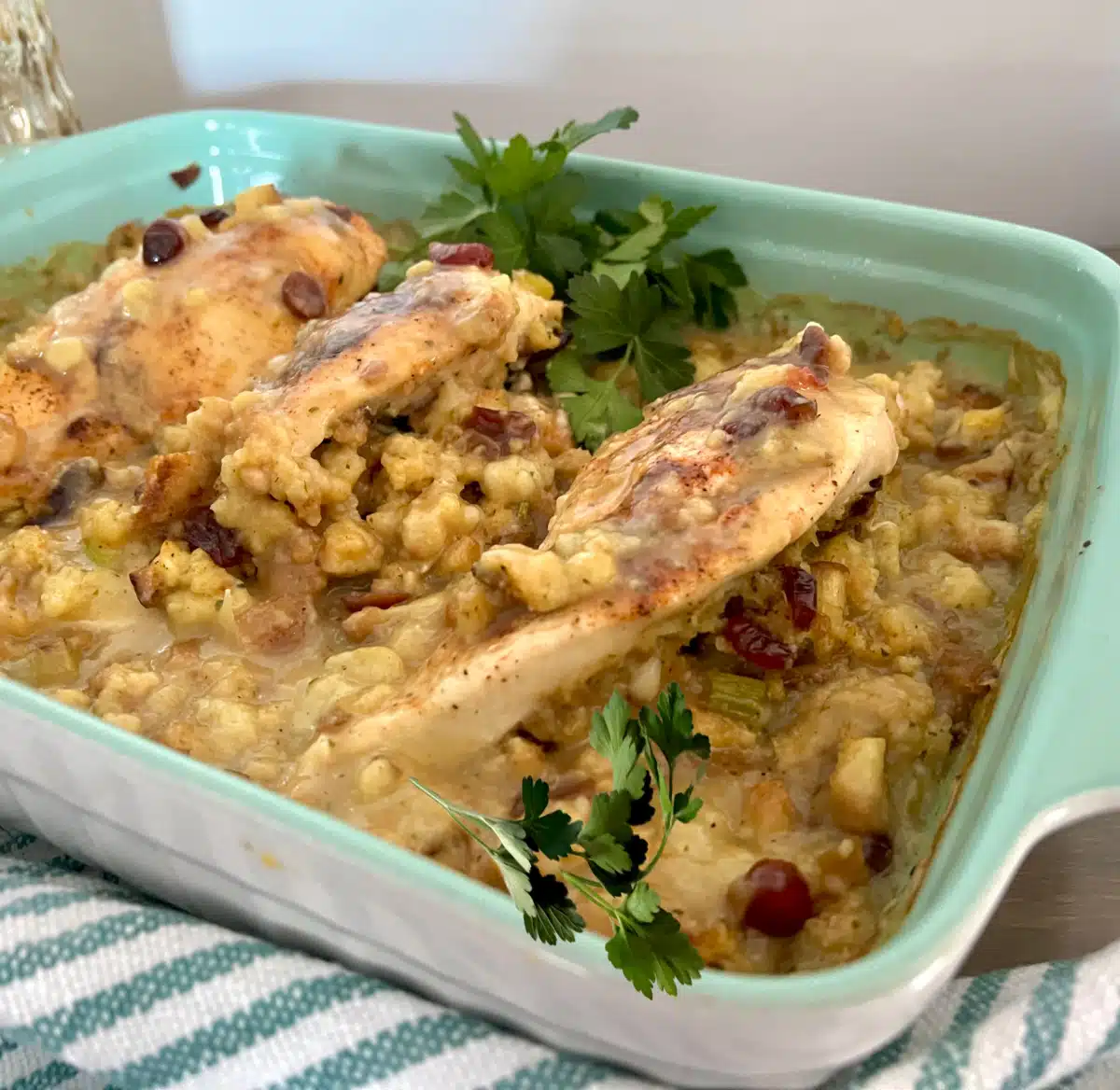 stuffed chicken breasts with stuffing and gravy in a blue baking dish