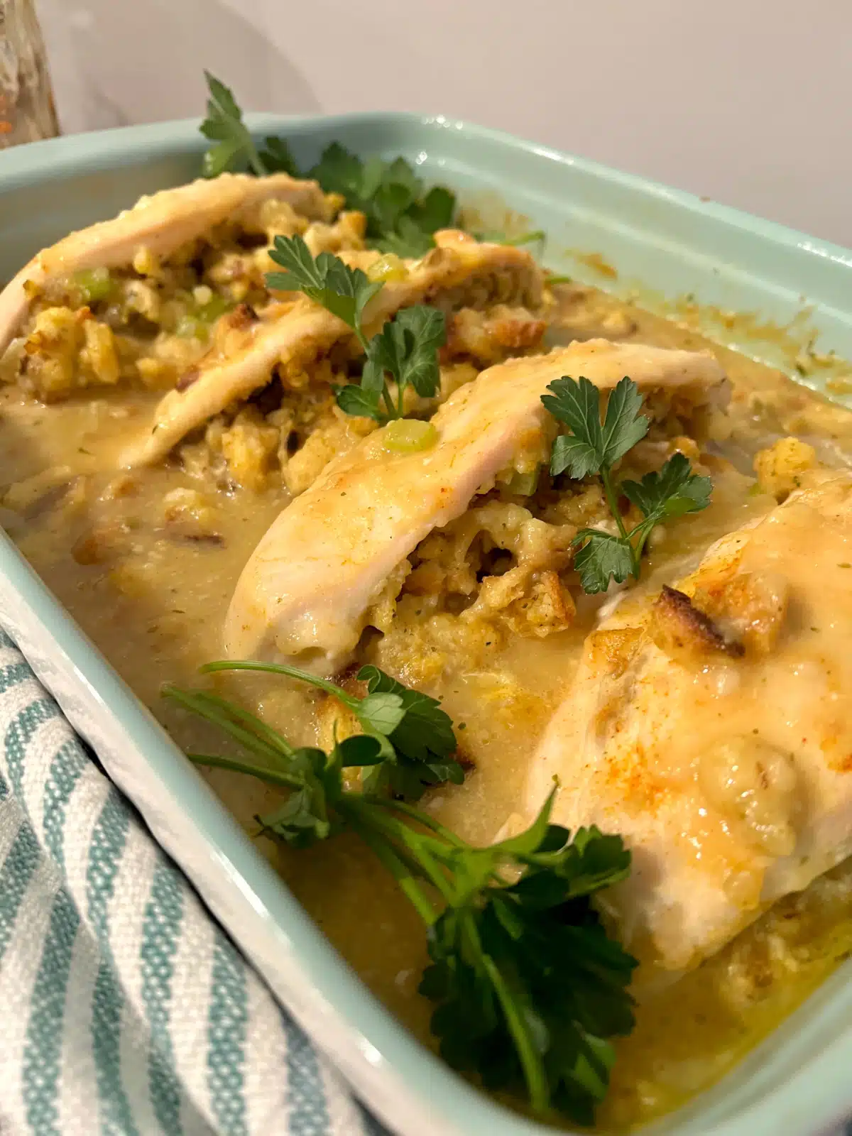 stuffed chicken breast casserole with parsley garnish
