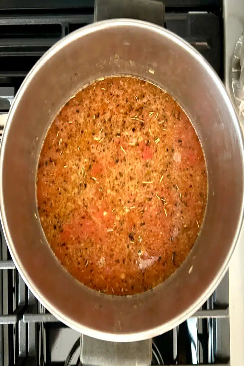 making tomato broth in a saucepot