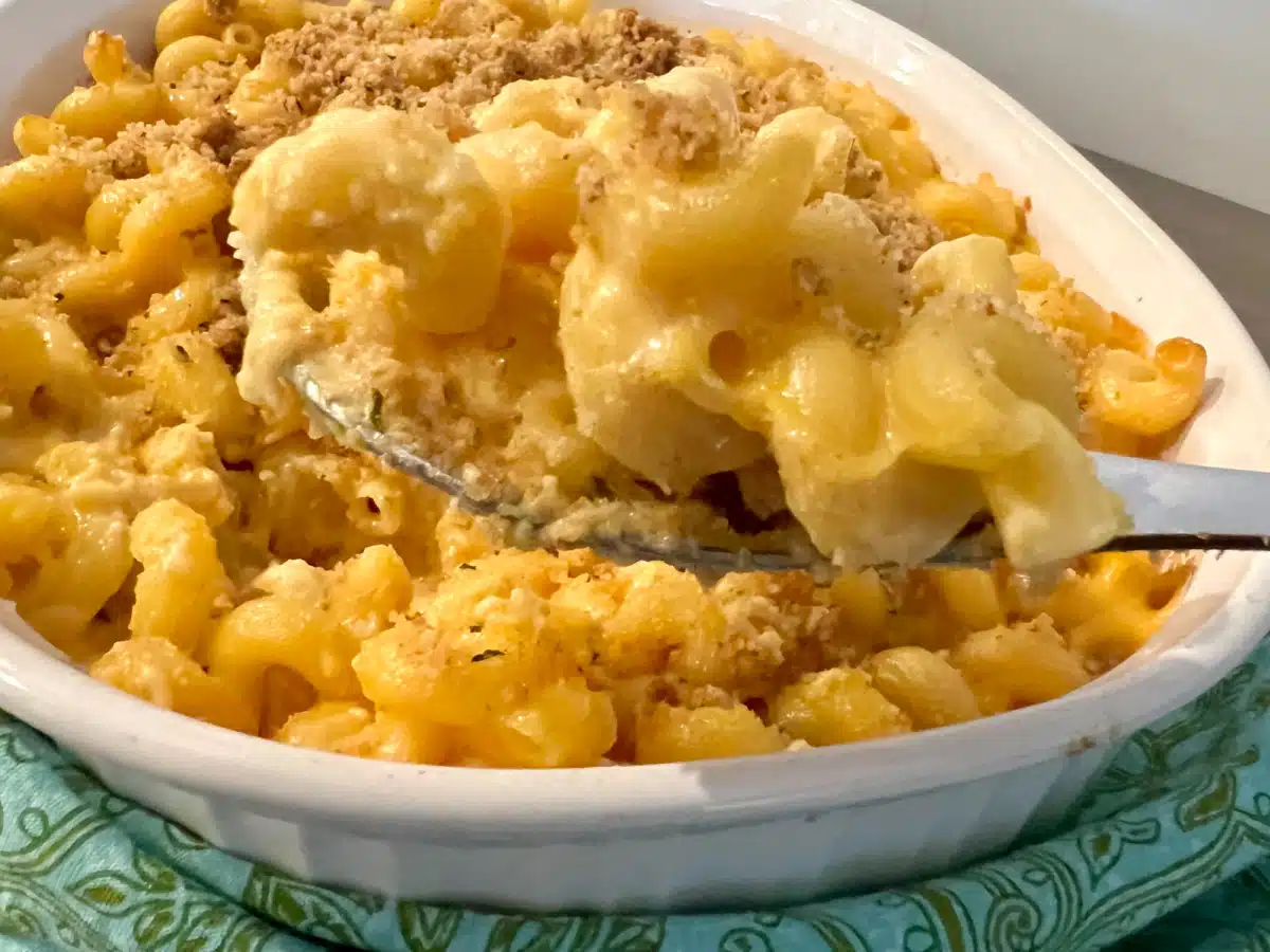 baking dish of mac and cheese with spoonful