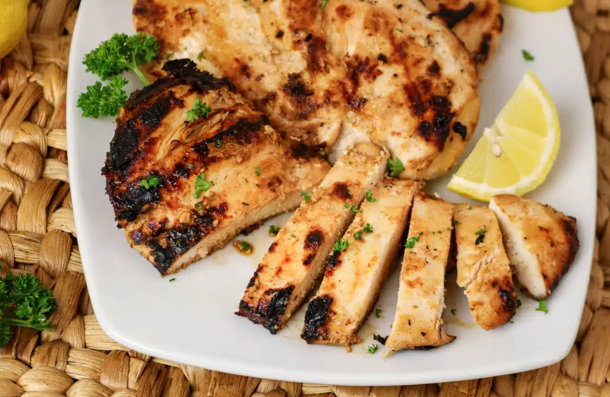 sliced marinated greek yogurt chicken on a white dish