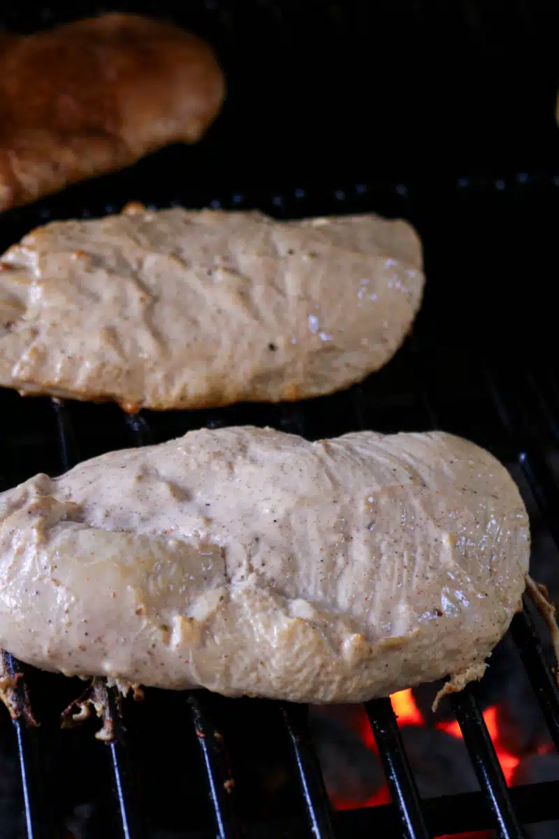 cooking marinated chicken on the grill