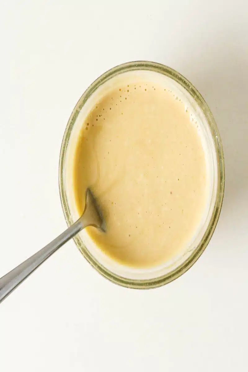 a creamy sauce with a spoon