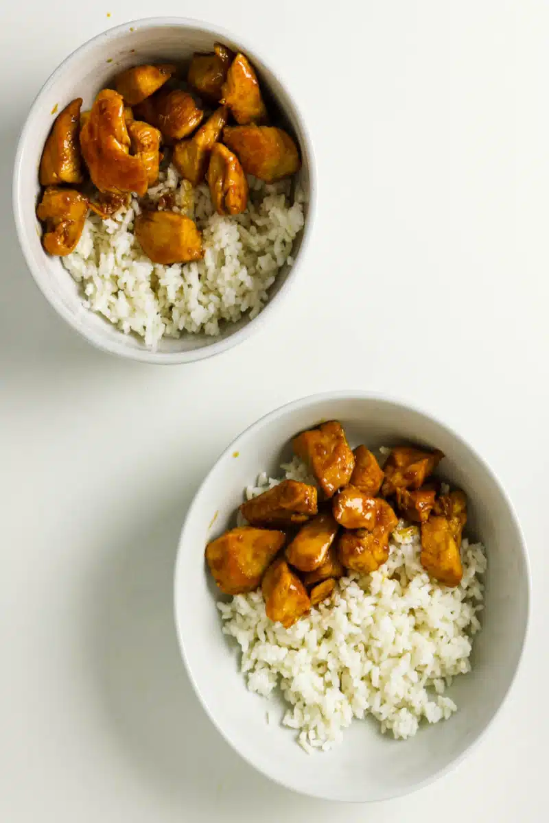 assembling the chicken bowls with rice and teriyaki chicken