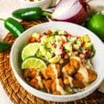pineapple salsa chicken bowl on a woven placement