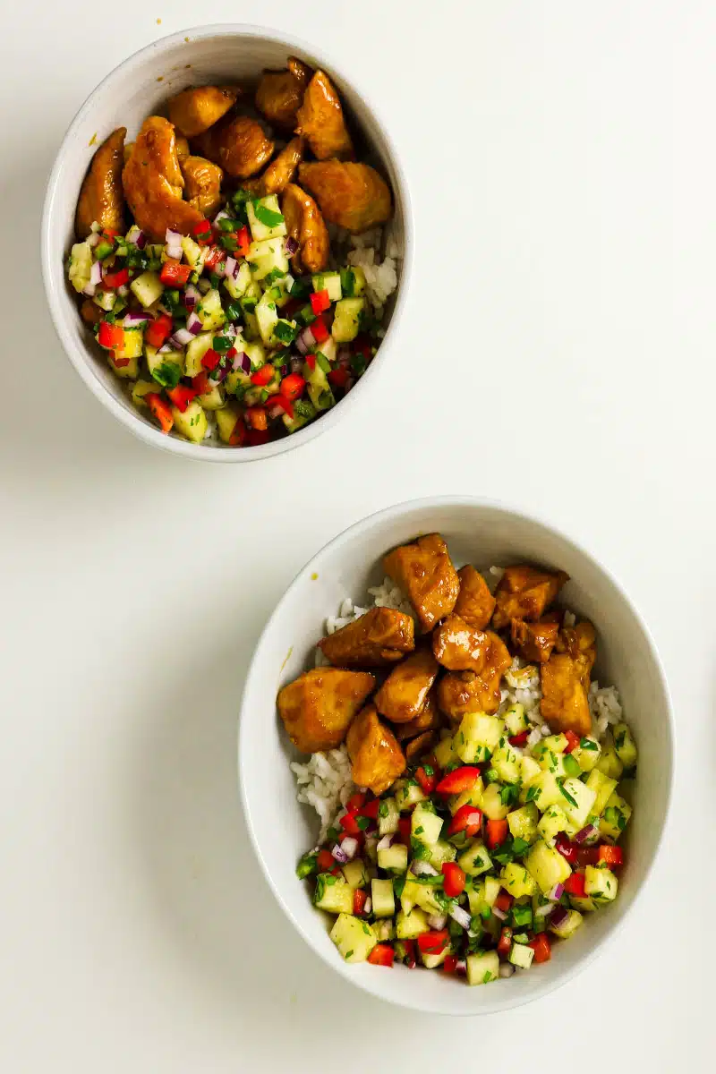 chicken, rice and pineapple salsa in two bowls