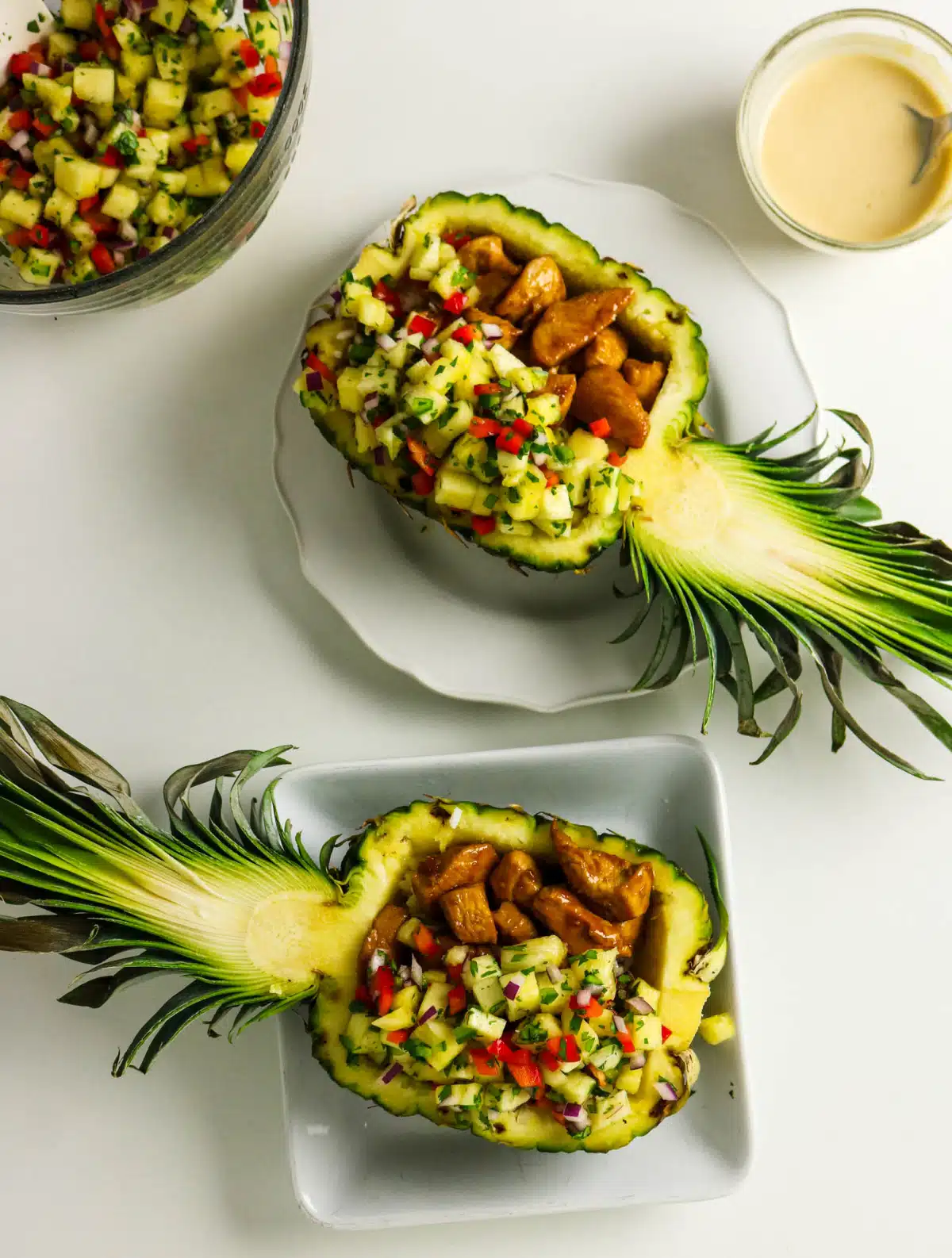 chicken rice and pineapple salsa in half of a fresh pineapple