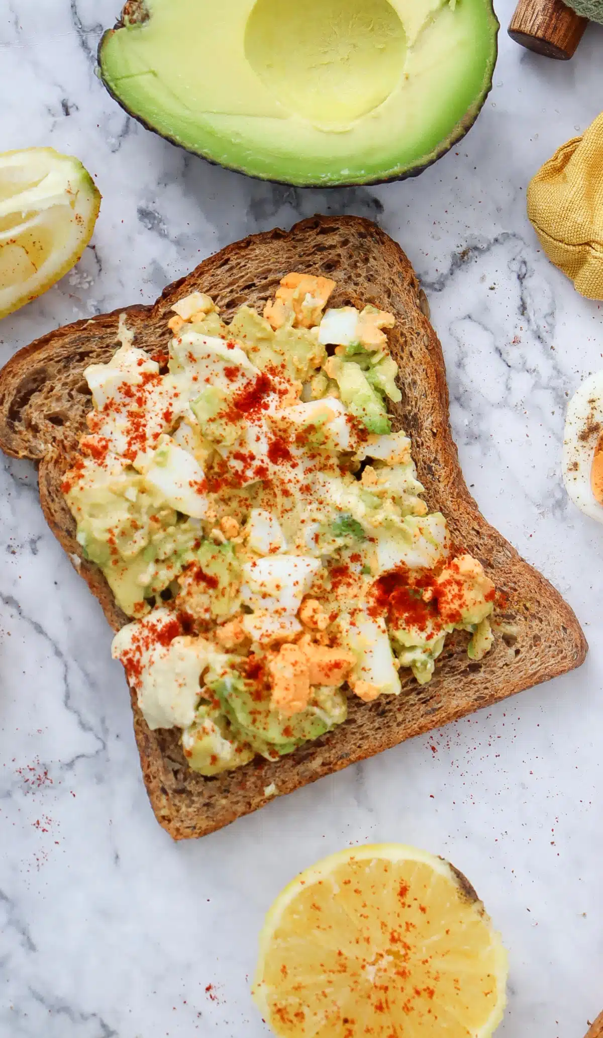 one slice of toast with avocado salad egg