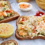 two open faced avocado egg salad sandwiches