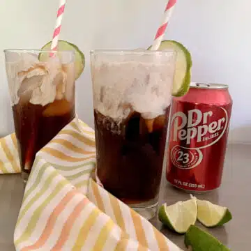two glasses of dirty Doctor Pepper sodas with soda can and lime wedges