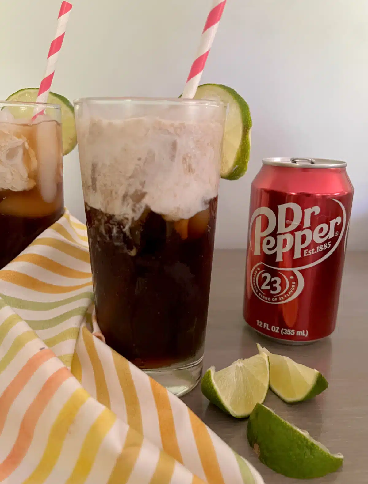a glass of dirty soda with doctor pepper soda can