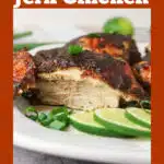 piece of jerk chicken sliced with lime and scallion